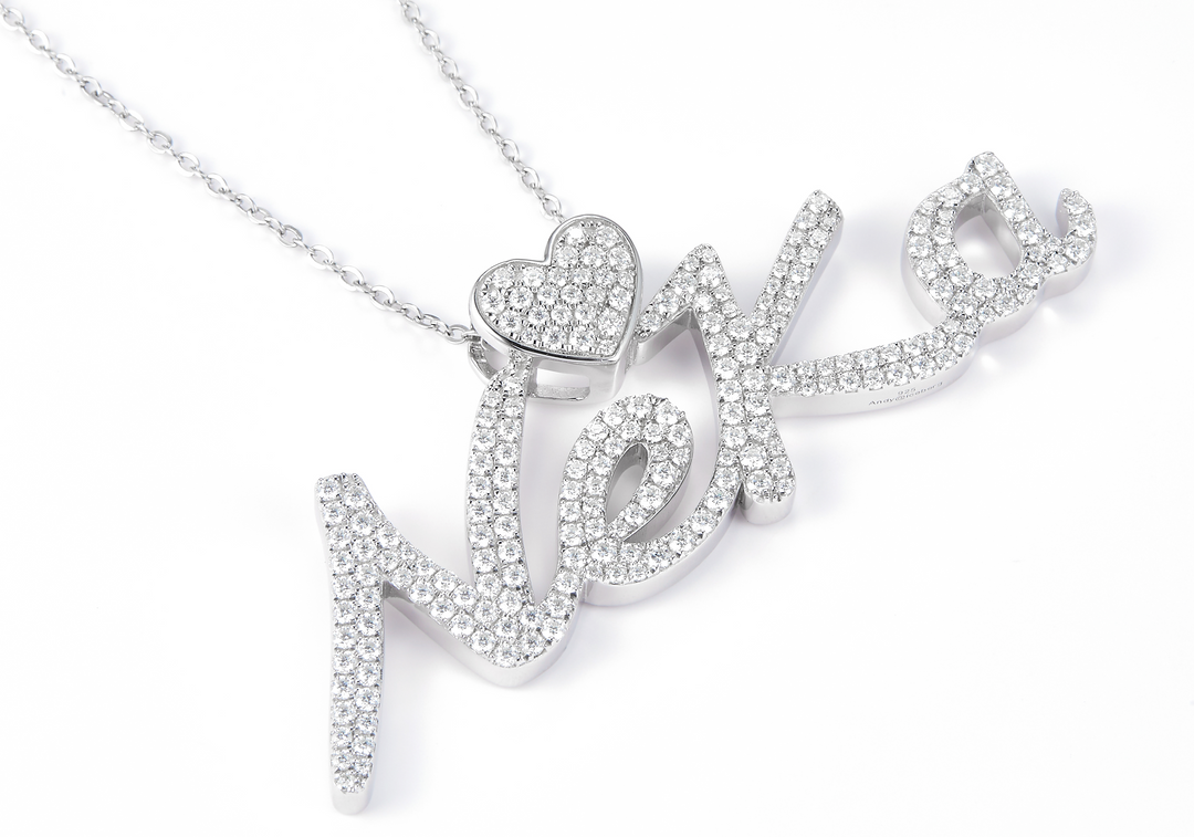 white gold necklace with diamonds with a nameplate that says Neka 